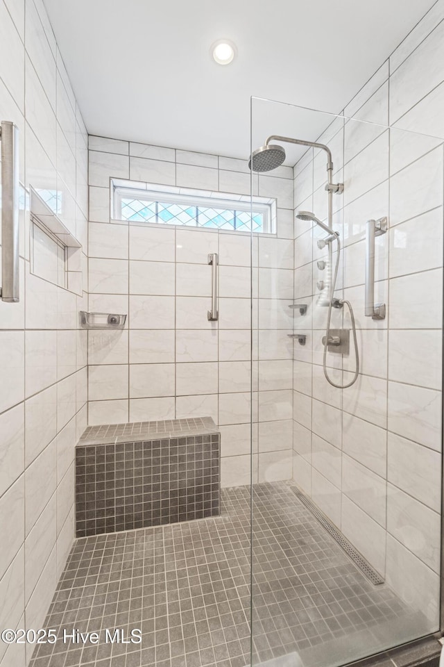 bathroom featuring plenty of natural light and a shower with door