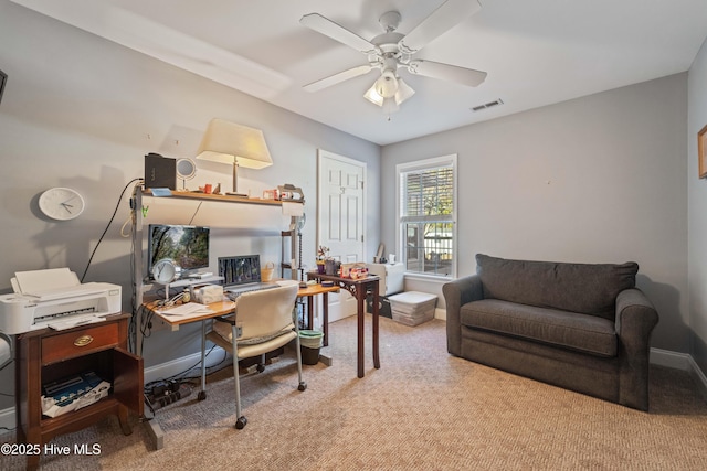 home office with ceiling fan and light carpet