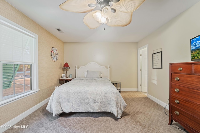 bedroom featuring ceiling fan and light carpet