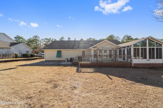 back of property with a patio area, a sunroom, and a wooden deck