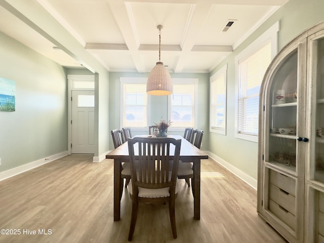 dining room with beamed ceiling, ornamental molding, coffered ceiling, and light hardwood / wood-style flooring