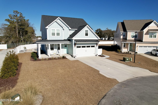 view of front of home with a garage, covered porch, and a front lawn