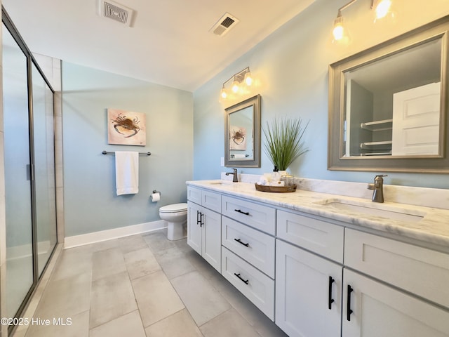 bathroom with vanity, a shower with door, and toilet