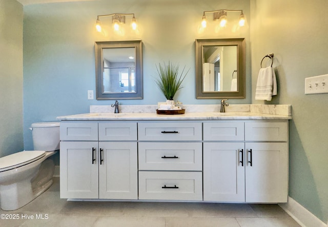 bathroom featuring vanity, tile patterned floors, and toilet