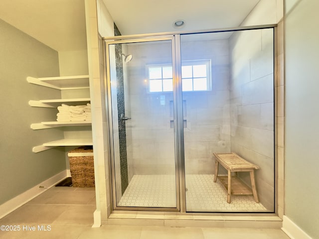 bathroom featuring tile patterned floors and a shower with door