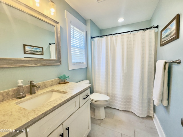 bathroom with vanity, tile patterned floors, and toilet