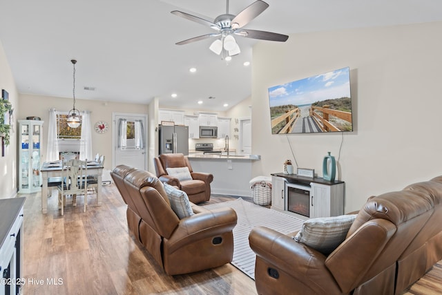 62 NE Dr NW, Calabash, NC 28467 - living area featuring a ceiling fan, light wood finished floors, vaulted ceiling, and recessed lighting