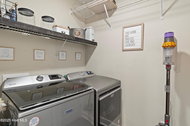 clothes washing area with washing machine and dryer