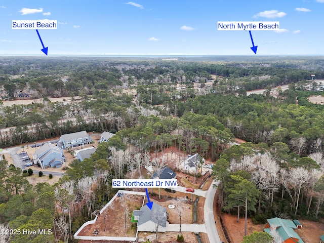62 NE Dr NW, Calabash, NC 28467 - aerial view of property and surrounding area with a heavily wooded area