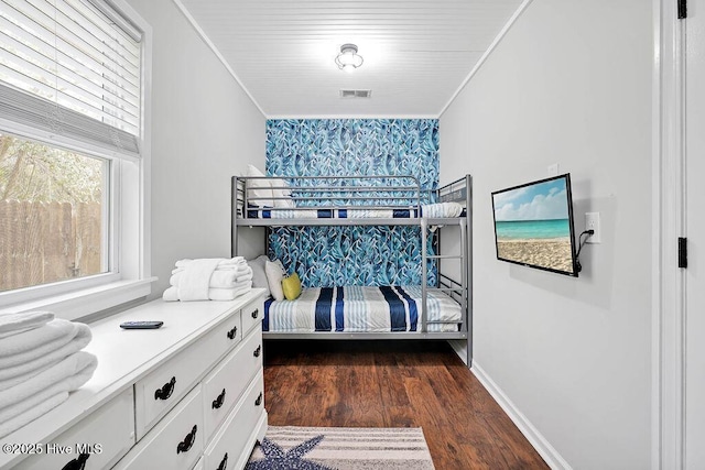 bedroom with dark hardwood / wood-style floors and crown molding