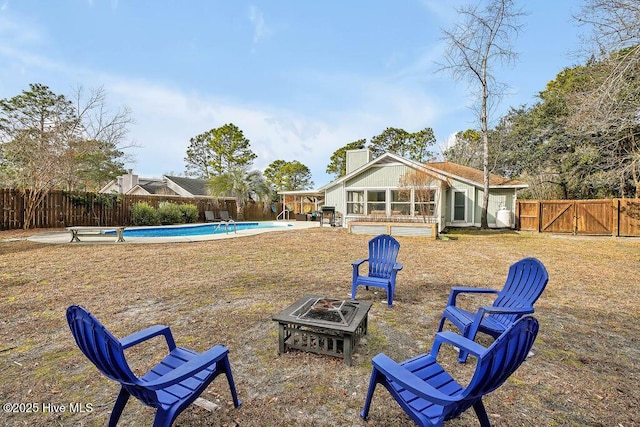 view of yard with a fire pit and a fenced in pool