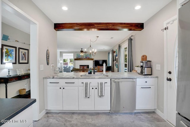 kitchen featuring light stone countertops, white cabinetry, sink, beam ceiling, and stainless steel appliances