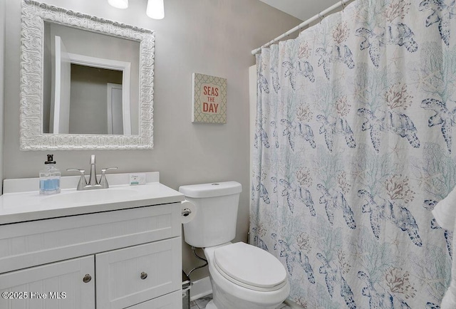 bathroom with a shower with curtain, toilet, and vanity