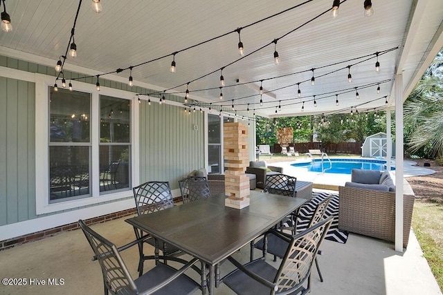 view of patio with a fenced in pool and a shed