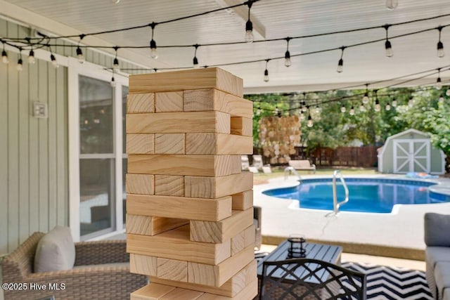 view of swimming pool featuring a storage shed