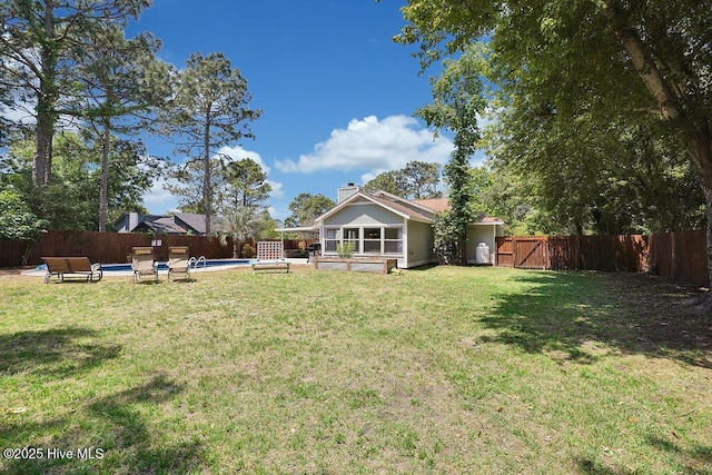 view of yard with a fenced in pool