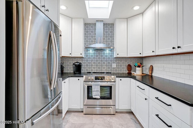 kitchen featuring white cabinets, stainless steel appliances, and wall chimney exhaust hood