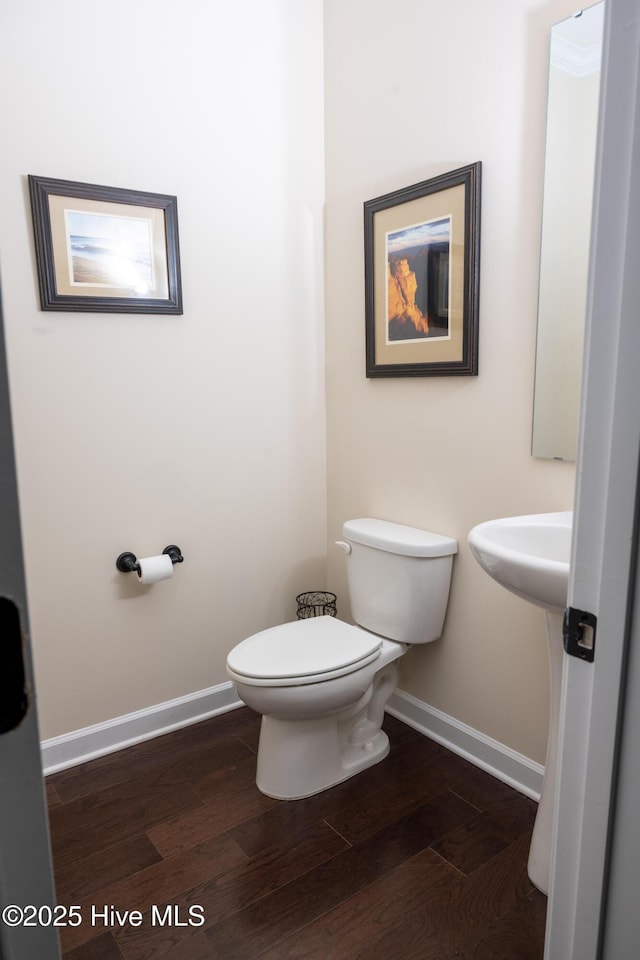 bathroom featuring hardwood / wood-style flooring and toilet