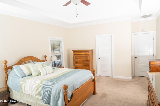 carpeted bedroom featuring crown molding and ceiling fan