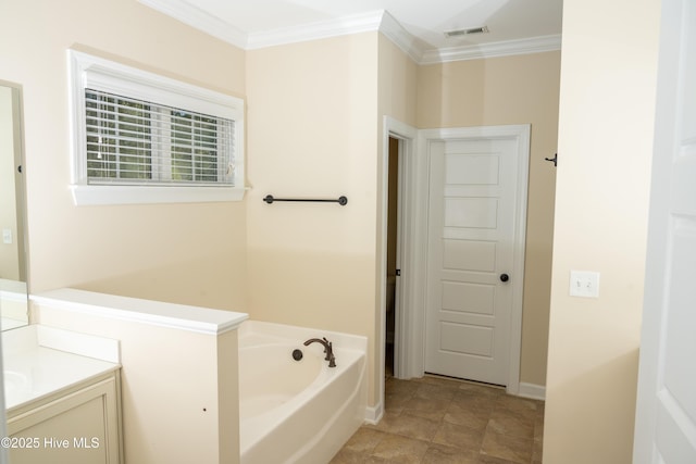 bathroom with ornamental molding, vanity, and a tub to relax in