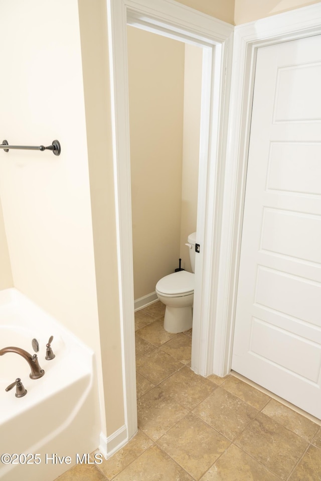 bathroom with toilet and a bathing tub