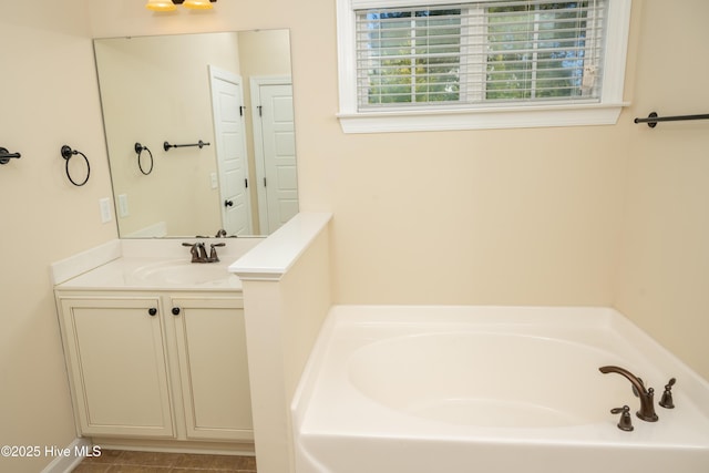 bathroom with tile patterned floors, vanity, and a bathtub