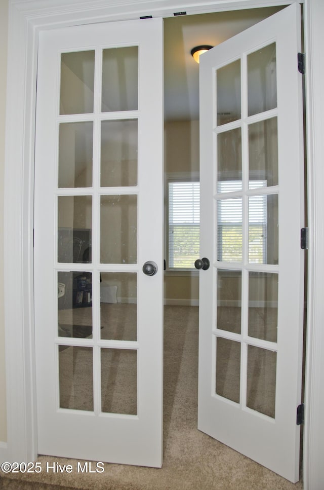 doorway to outside with french doors and carpet flooring