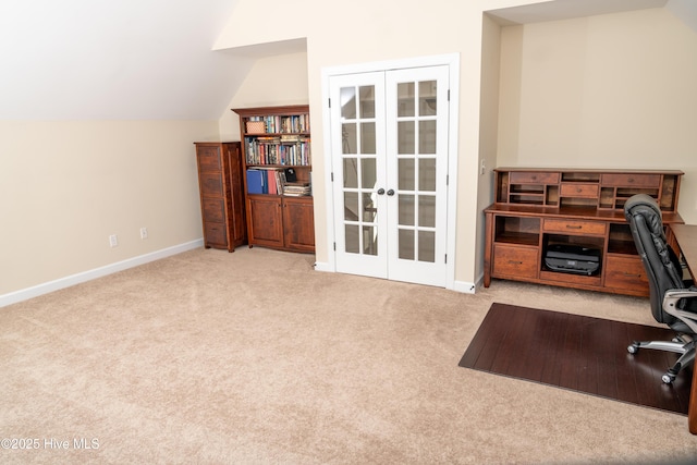 carpeted office space featuring lofted ceiling and french doors