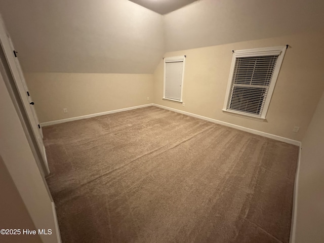 bonus room featuring vaulted ceiling and carpet flooring