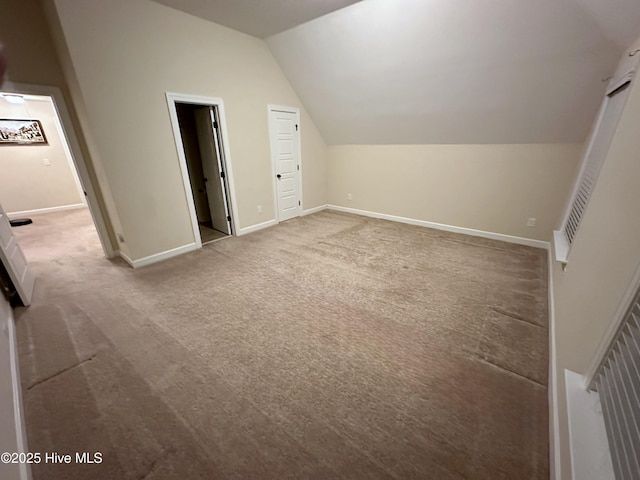 bonus room with lofted ceiling and carpet