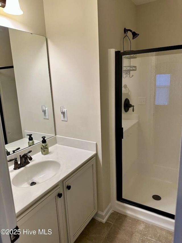 bathroom with vanity, an enclosed shower, and tile patterned flooring