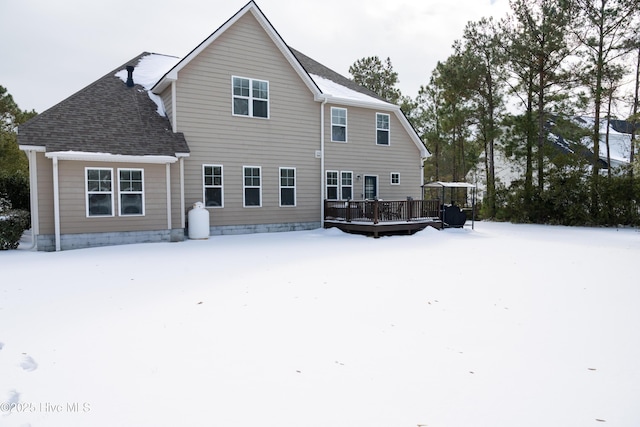 snow covered property featuring a deck