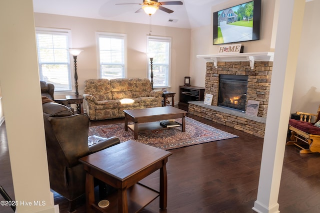 living room with hardwood / wood-style flooring, ceiling fan, and a fireplace