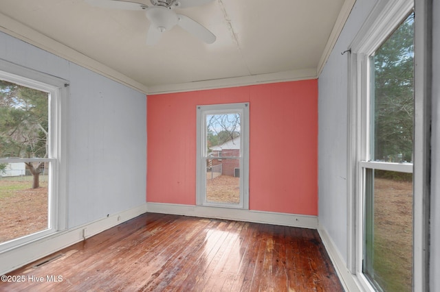 unfurnished room with dark hardwood / wood-style floors, ceiling fan, and ornamental molding