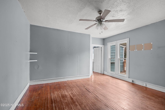 spare room featuring ceiling fan, a textured ceiling, and wood-type flooring