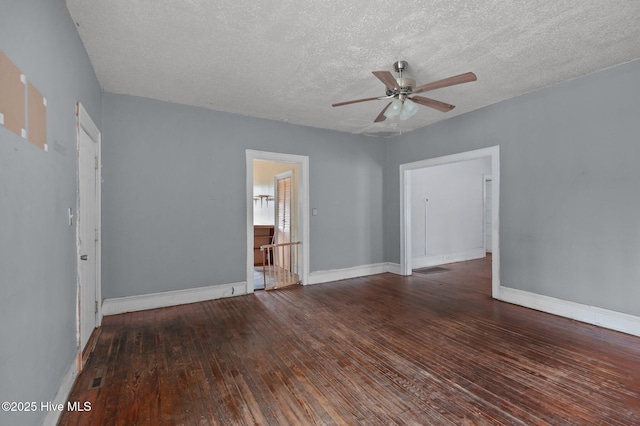 spare room with ceiling fan, dark wood-type flooring, and a textured ceiling