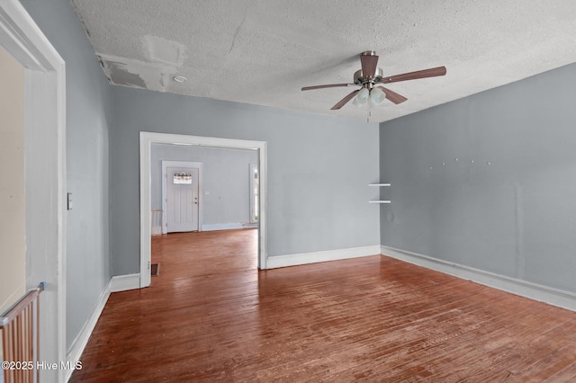 unfurnished room with wood-type flooring, a textured ceiling, and ceiling fan