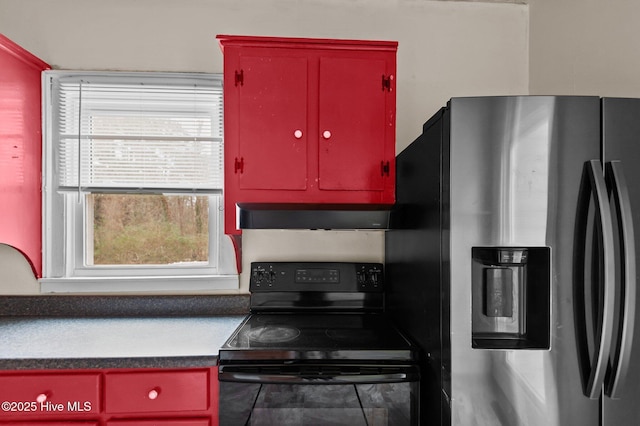 kitchen featuring range hood, stainless steel fridge, and black electric range