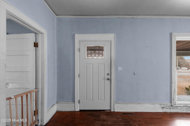 foyer featuring dark hardwood / wood-style floors and crown molding