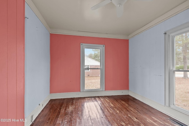 empty room with hardwood / wood-style flooring, ornamental molding, and ceiling fan