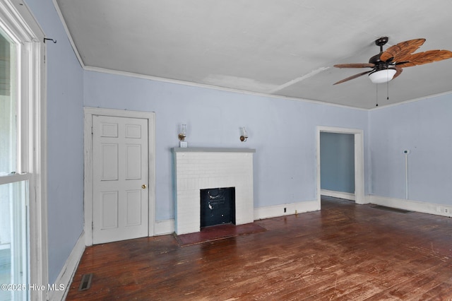 unfurnished living room featuring a fireplace, dark wood-type flooring, ceiling fan, and ornamental molding