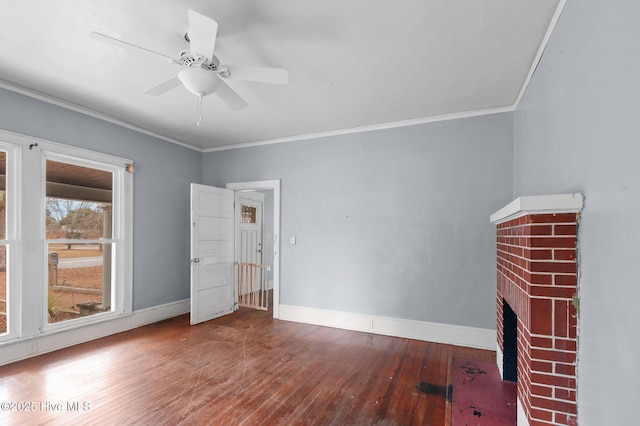 unfurnished living room with wood-type flooring, ceiling fan, a brick fireplace, and ornamental molding