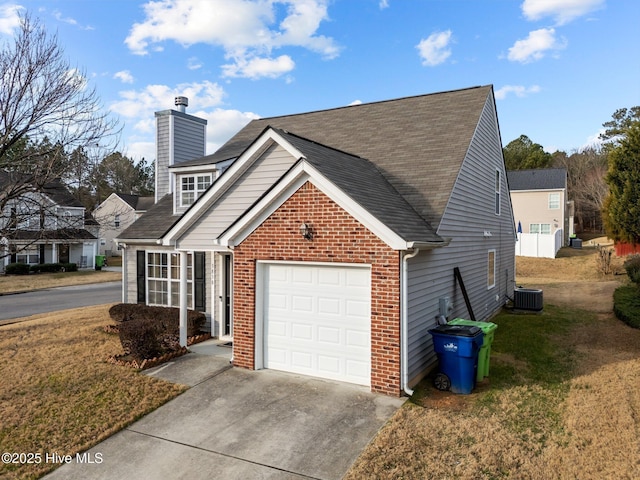 view of side of home with a garage, central AC, and a lawn