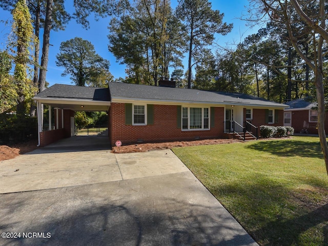 ranch-style house featuring a front yard and a carport