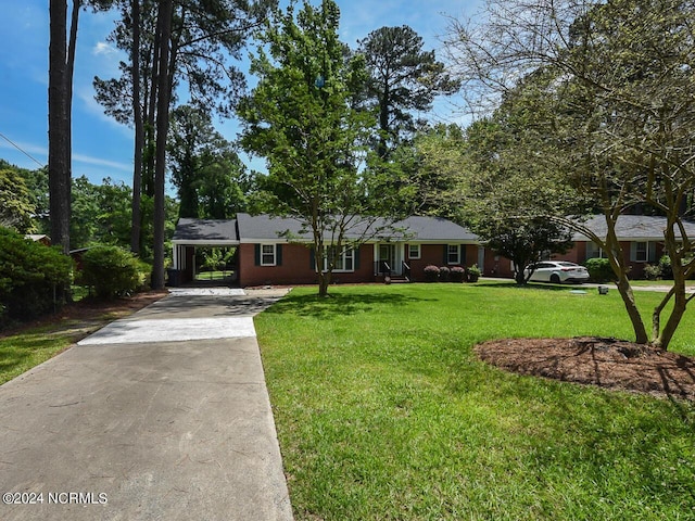 ranch-style home with a carport and a front lawn