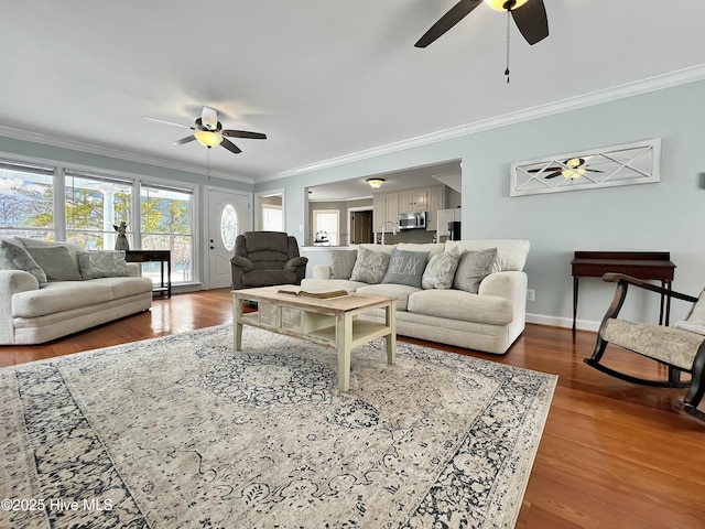 living room featuring crown molding, ceiling fan, and hardwood / wood-style flooring