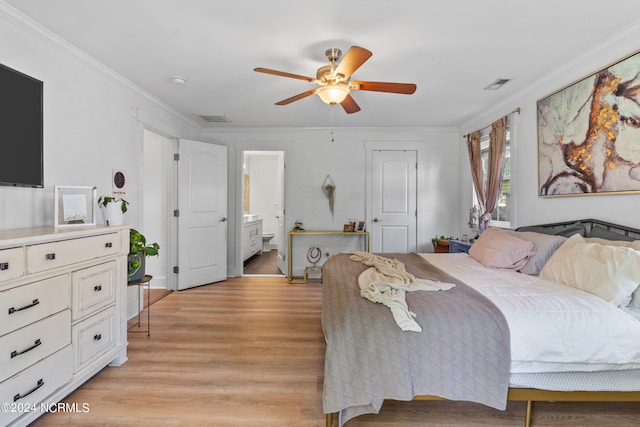 bedroom with crown molding, ensuite bath, ceiling fan, and light hardwood / wood-style flooring