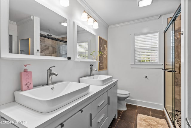 bathroom featuring ornamental molding, a healthy amount of sunlight, toilet, and a shower with shower door