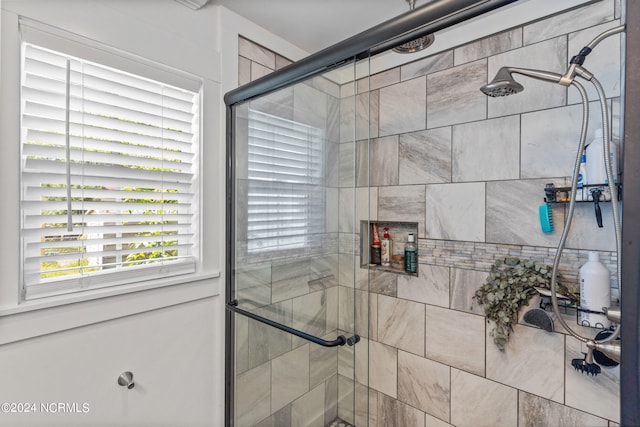 bathroom with a shower with door