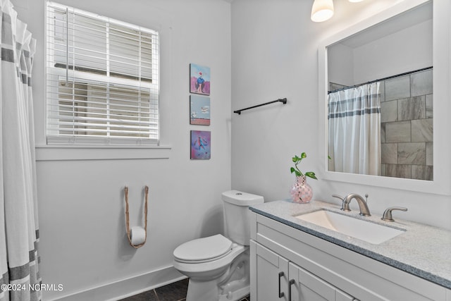 bathroom with vanity, tile patterned floors, and toilet